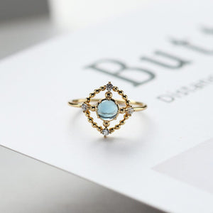 Openwork disc London blue topaz ring